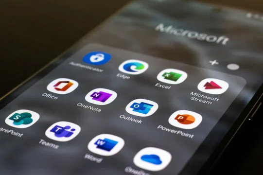 Microsoft nonprofit licenses to end. a phone screen with microsoft 365 apps on display