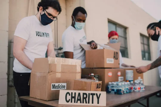 Microsoft charity licence ending. charity workers with donation boxes