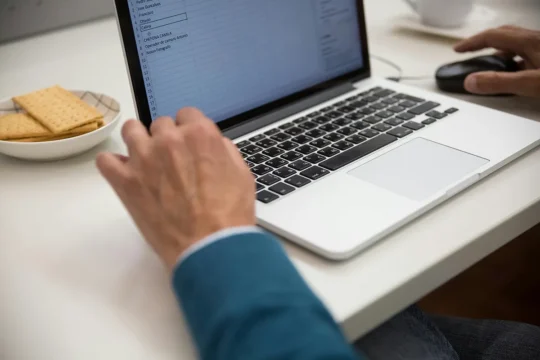 a worker on a laptop using excel. benefits of ai